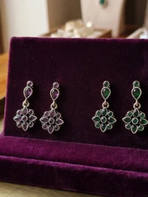 Colors of elegance – purple and green gemstone earrings with floral charm.